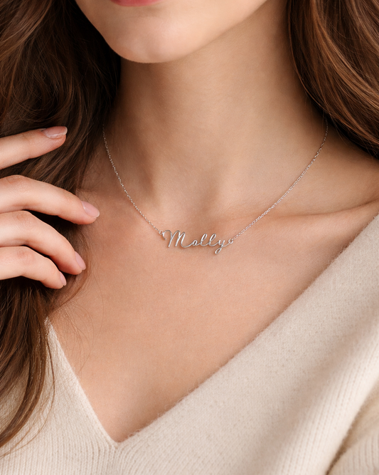 Necklace with 'Mallory' nameplate worn by a person against a neutral background