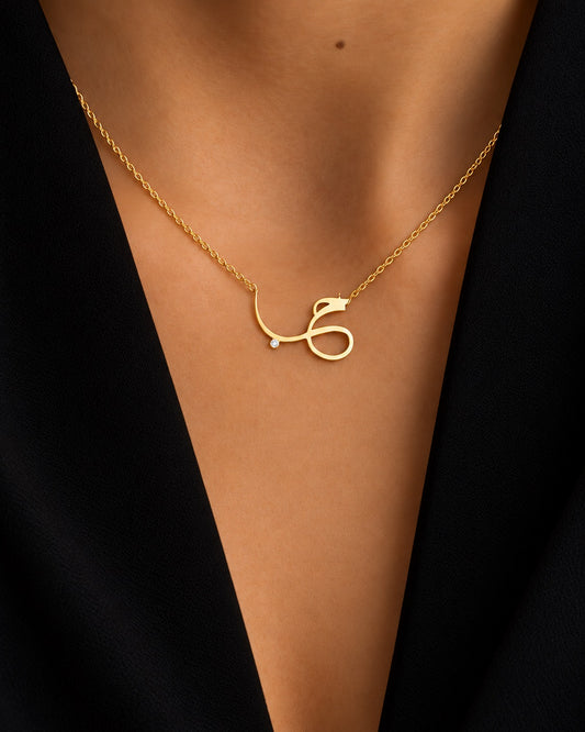 Hob pendant necklace in a gold-plated finish, worn on the neck