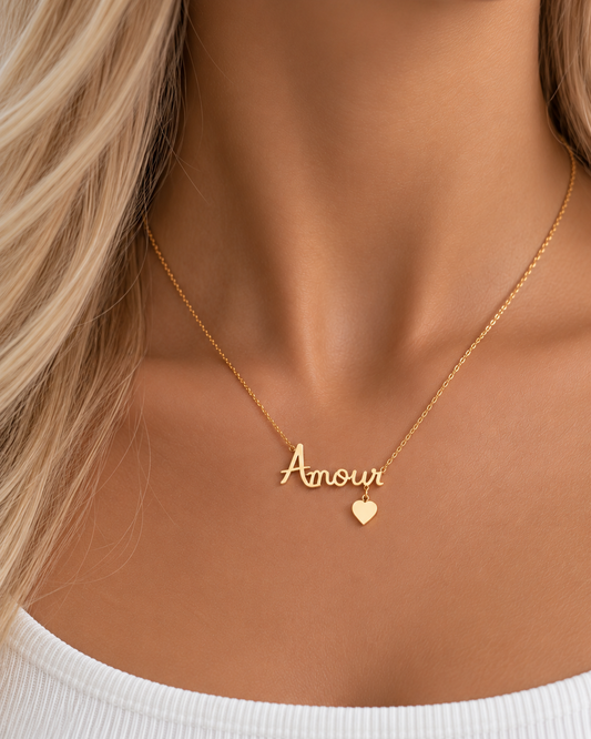 Gold-plated Amour script necklace with heart charm worn at the collarbone