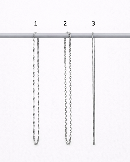 Three silver chain necklaces of different lengths on a white background