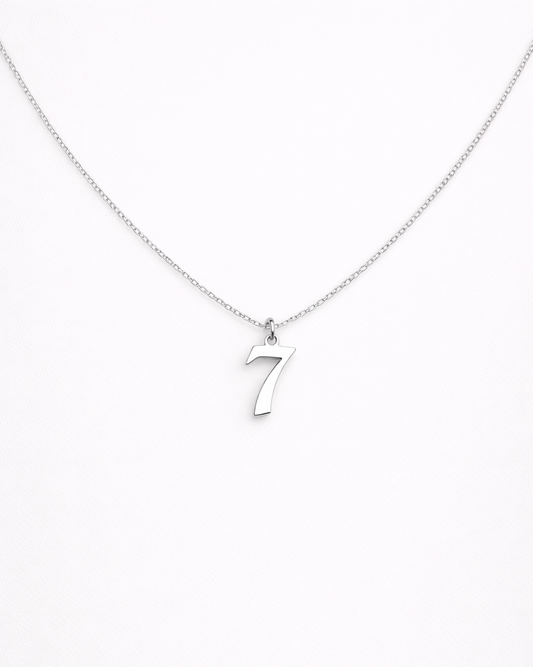 Silver necklace with a number '7' pendant on a white background