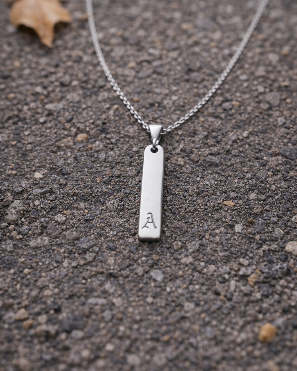 Silver necklace with a pendant on a textured surface