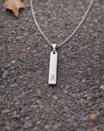 Silver necklace with a pendant on a textured surface