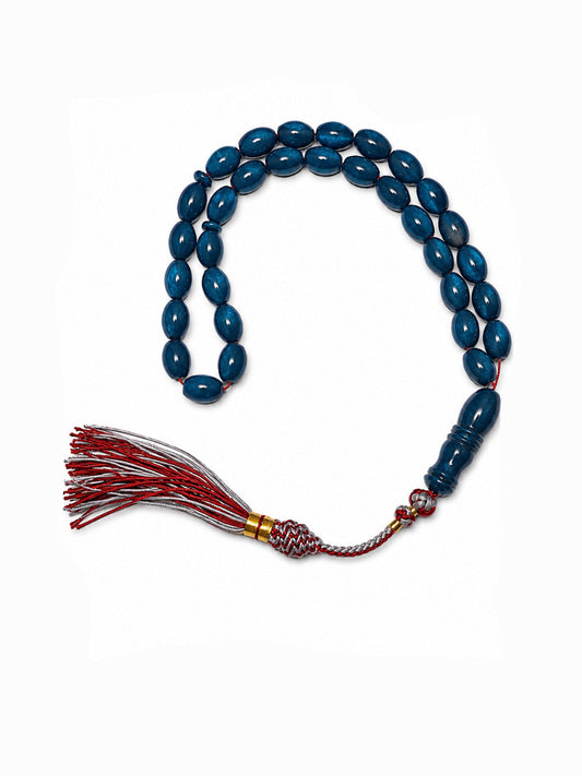 Blue beaded necklace with a red tassel on a white background