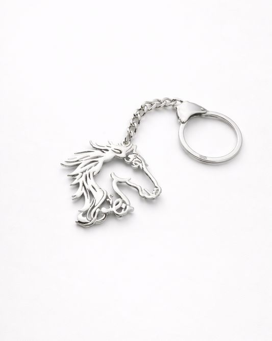 Silver horse head keychain on a white background