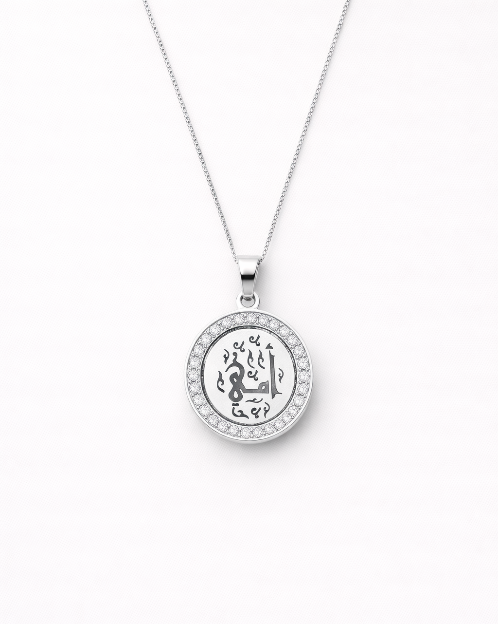 Silver necklace with a round pendant on a white background