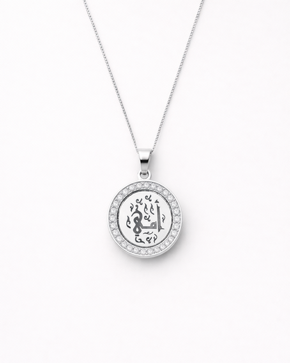 Silver necklace with a round pendant on a white background