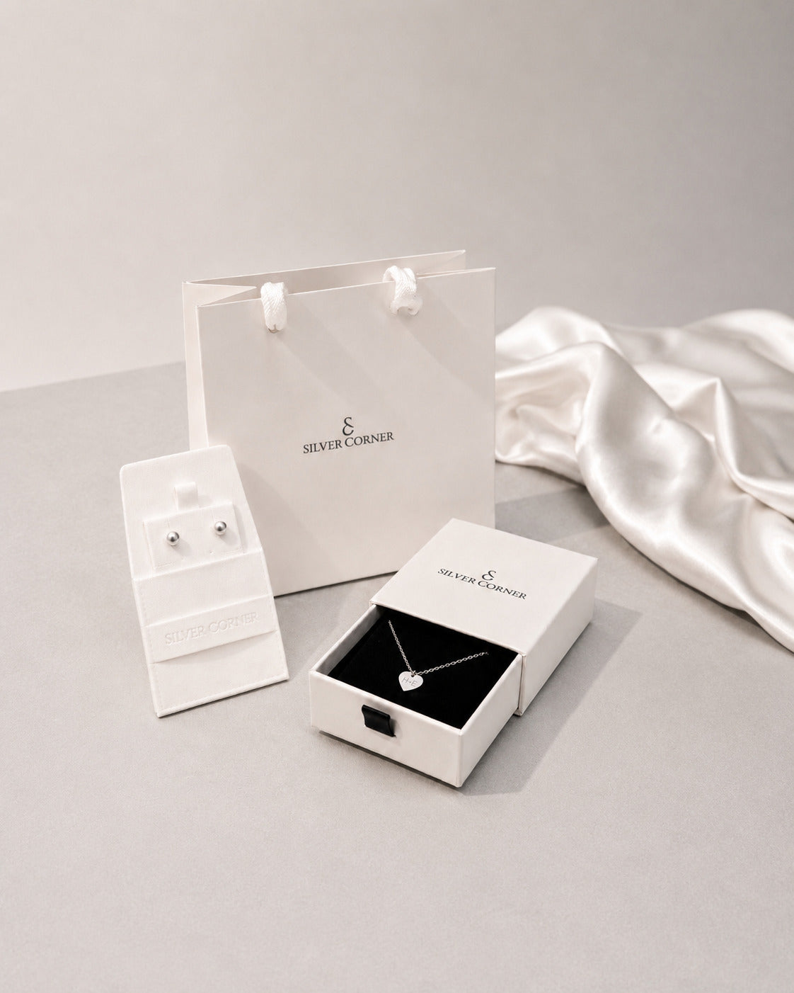 Silver Corner gift packaging with white gift bag, earring box and necklace box