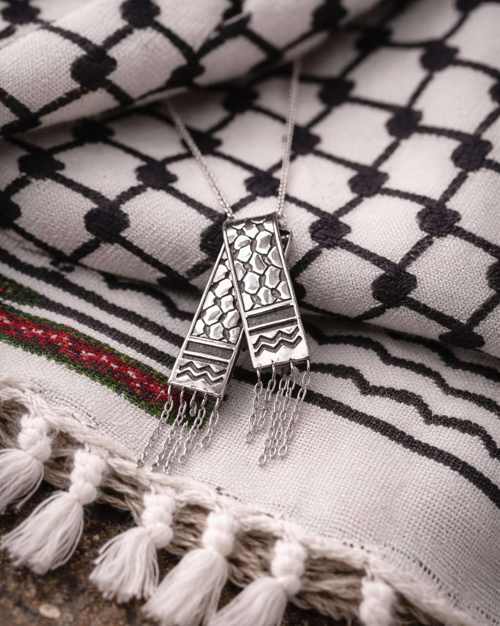 Decorative necklace with tassels on a patterned fabric background