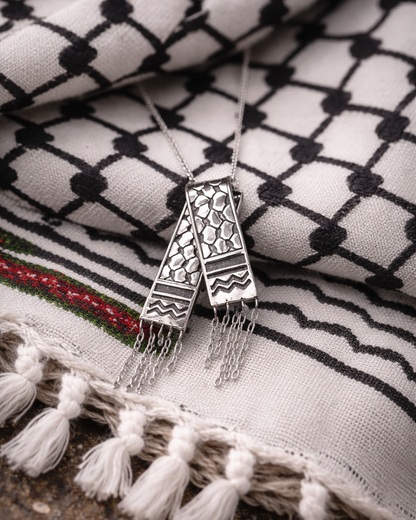 Decorative necklace with tassels on a patterned fabric background