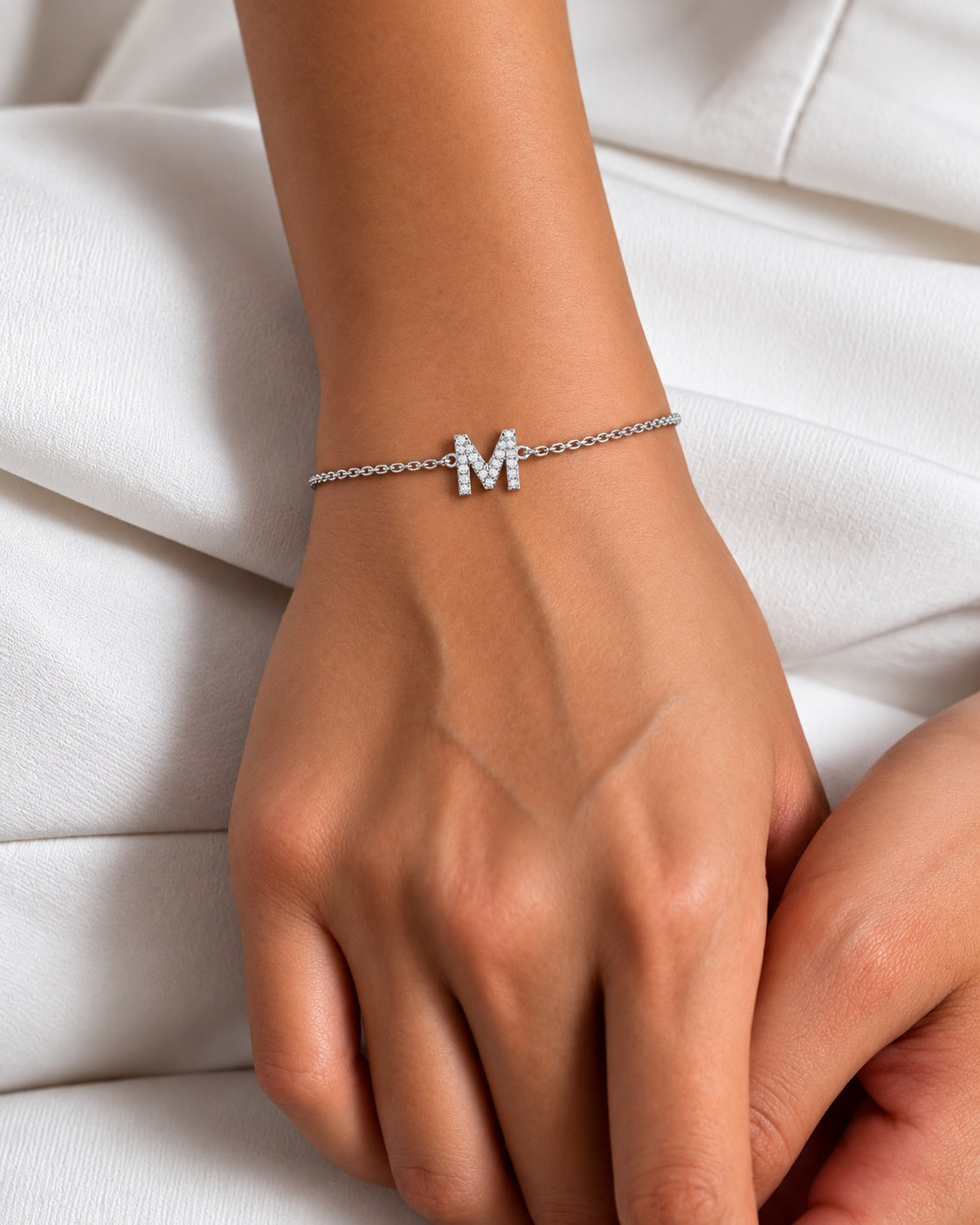 Zircon initial bracelet in 925 silver, worn on the wrist